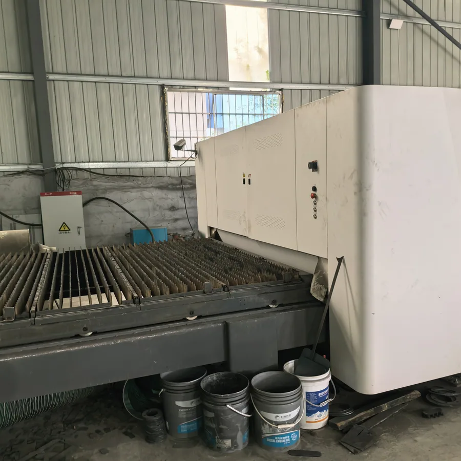 Laser cutting machine cutting generator canopy panels at the factory